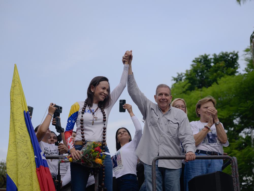 Opposition candidate Edmundo González Urrutia (right) and party leader María Corina Machado wave to supporters in Las Mercedes on Thursday during their closing campaign event.