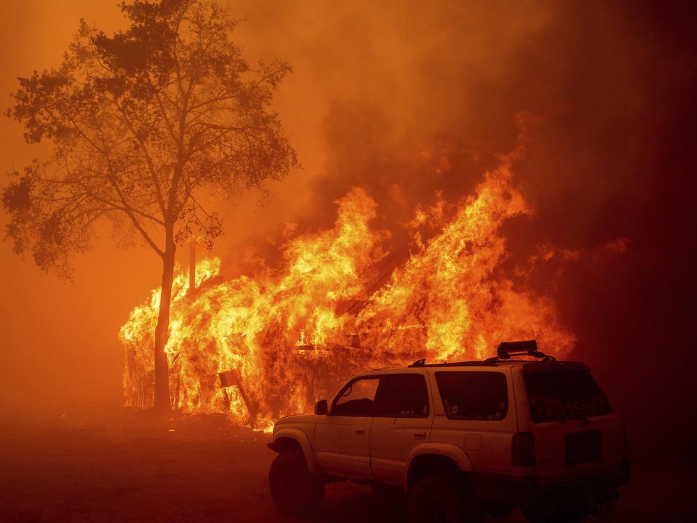 Flames consume a building as the Park Fire tears through the Cohasset community in Butte County, Calif., on Thursday.