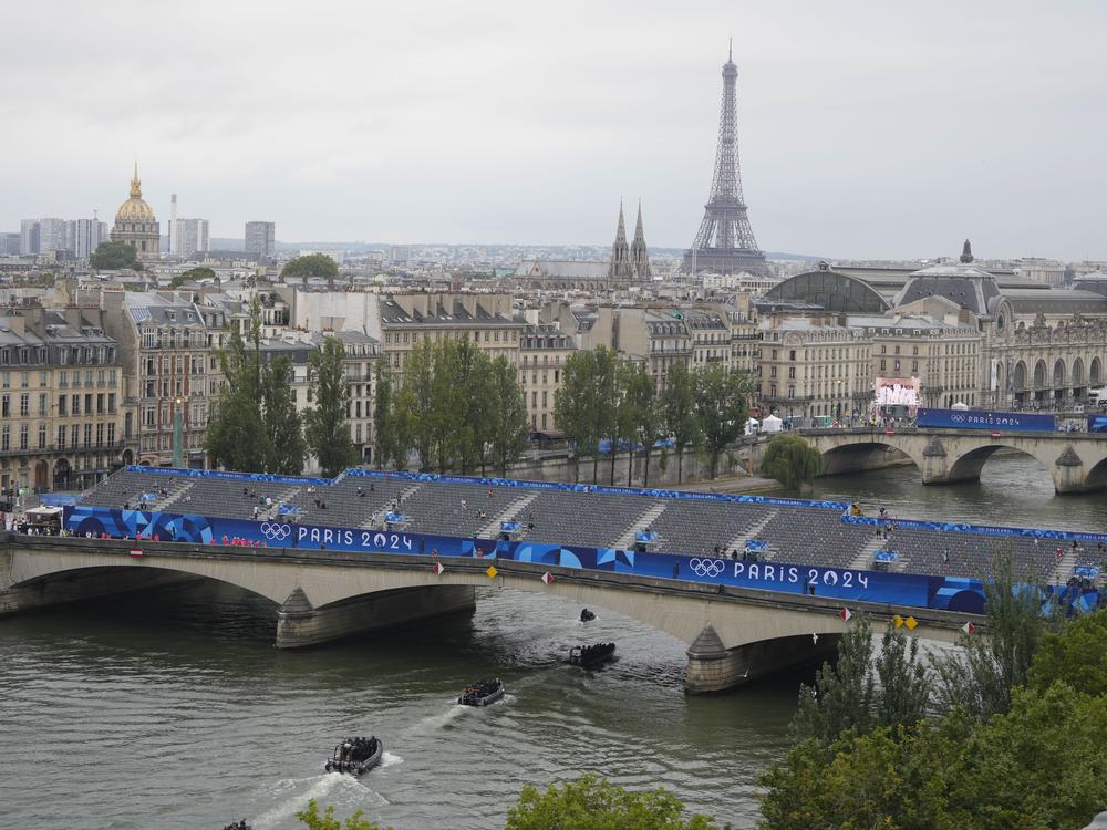 Police boats patrol the Seine river in Paris ahead of the opening ceremony of the 2024 Summer Olympics, Friday.
