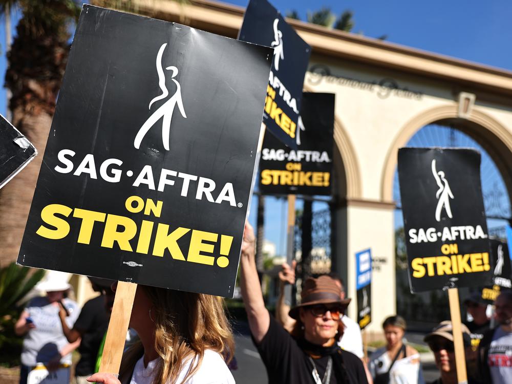 SAG-AFTRA members picket outside Paramount Studios in 2023. Members of the union were on strike between July and November during negotiations with Hollywood film and television studios. Now, the focus is on video games. 