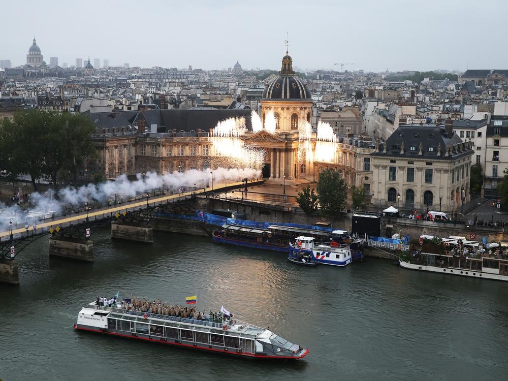 The Institut de France and the Pont des Arts bridge as a pyrotechnics display takes place whilst the boats of Team Cyprus, Team Colombia and Team Comoros pass by along the River Seine before French-Malian singer Aya Nakamura performed<strong> </strong>during the opening ceremony of the Olympic Games Paris 2024 on July 26, 2024 in Paris, France. 