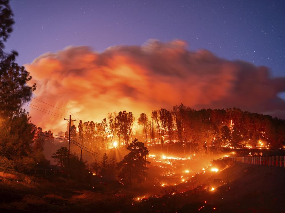 Seen in a long exposure photograph, the Park Fire burns along Highway 32 in the Forest Ranch community of Butte County, Calif., on Thursday, July 25, 2024.