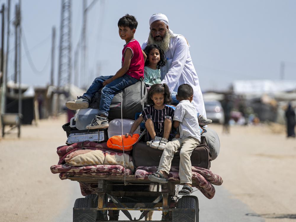 Palestinians displaced by the Israeli air and ground offensive on the Gaza Strip flee from parts of Khan Younis on Saturday, following an evacuation order by the Israeli army to leave parts of the southern area of Gaza Strip's second largest city.