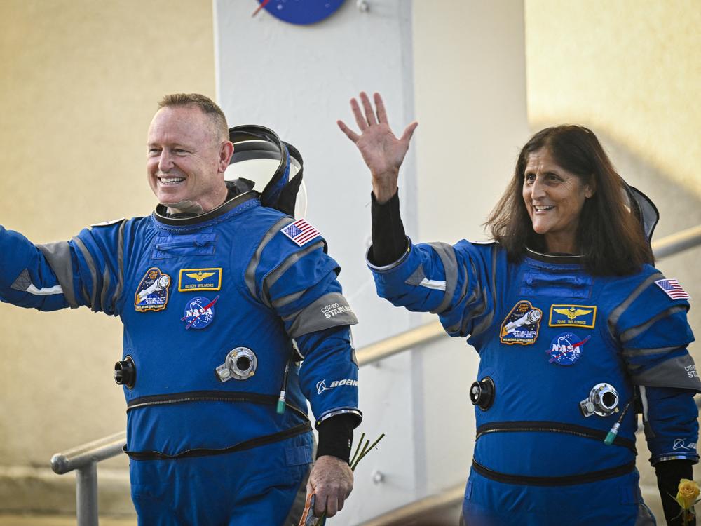 NASA astronauts Butch Wilmore and Suni Williams wave as they prepare to depart the Neil A. Armstrong Operations and Checkout Building at Cape Canaveral Space Force Station in Florida to board the Boeing CST-100 Starliner spacecraft on June 5.