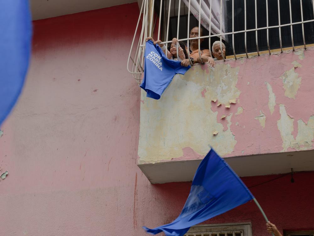 Residents wave a T-shirt with the name of Venezuelan opposition leader María Corina Machado in support of a campaign march in La Vega, a neighborhood of Caracas, on Wednesday.