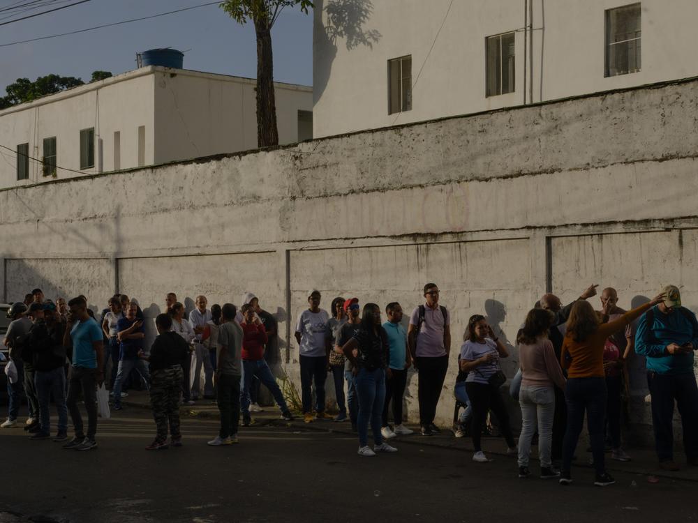 People prepare to vote in the Venezuelan presidential elections early in the morning on Sunday, in the capital city of Caracas. This voting center in Gato Negro, Catia, is where President Maduro cast his ballot. All over the country, people began waiting in lines outside their voting centers as early as 10 p.m. the night before.