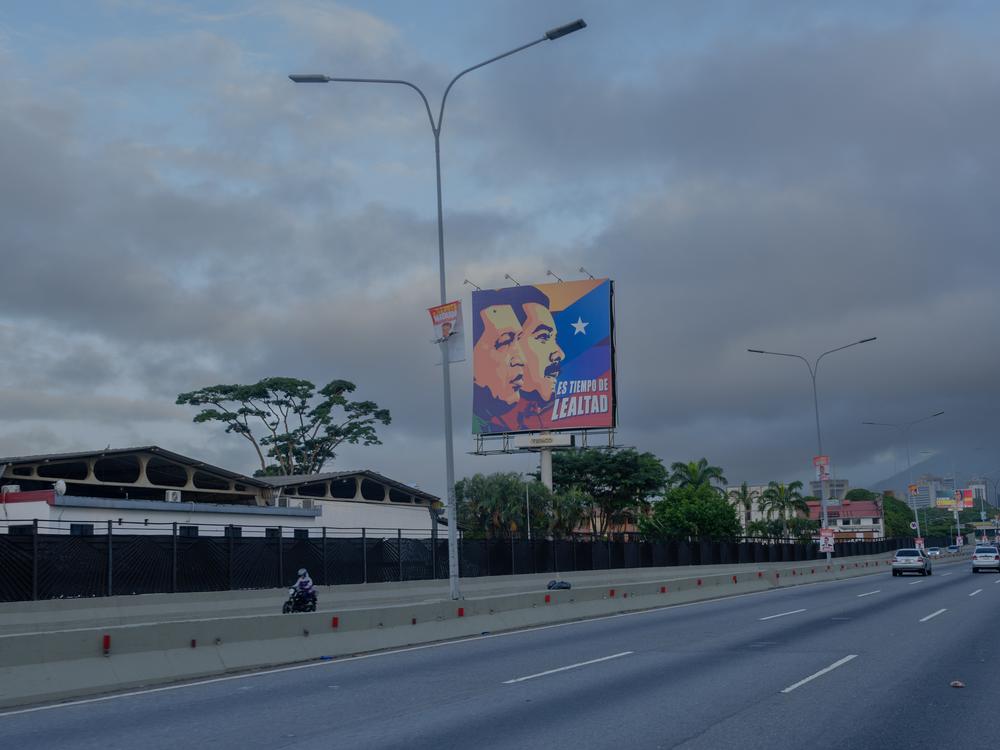 A billboard shows the faces of late President Hugo Chávez and incumbent President Nicolás Maduro and says “Time for loyalty,” on a highway in Caracas, Venezuela, on Sunday morning.