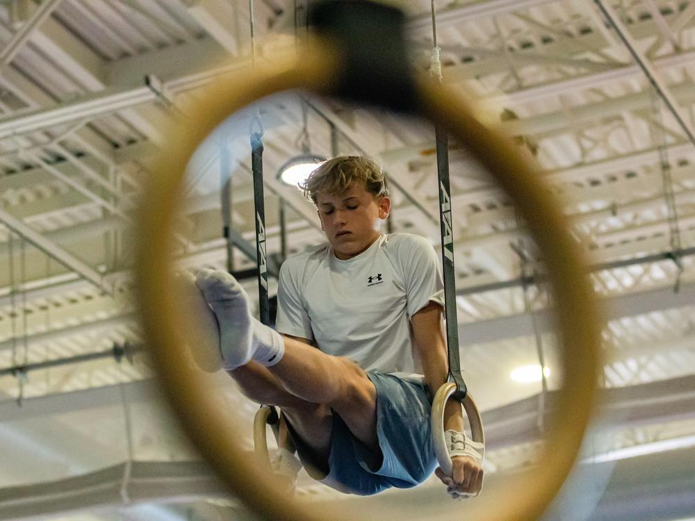 Hobie Biliouris, 14, of the Arlington Tigers gymnastics team practices on the rings at the Barcroft Sports & Fitness Center in Arlington, Va., on July 2. He recently joined the Tigers after his previous team ended its boys program.