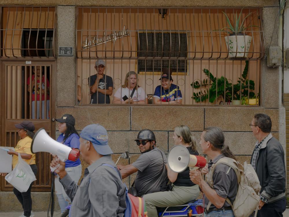 Residents and community organizers take the street in the La Vega neighborhood of Caracas, Venezuela, on Wednesday morning to show support for opposition candidate Edmundo Gónzalez, going door to door to explain the ballot.