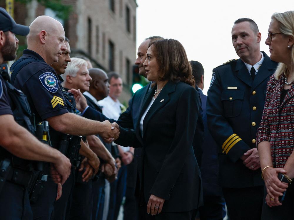 Vice President Harris speaks with police officers after a shooting that left seven people dead in Highland Park, Ill., on July 5, 2022.