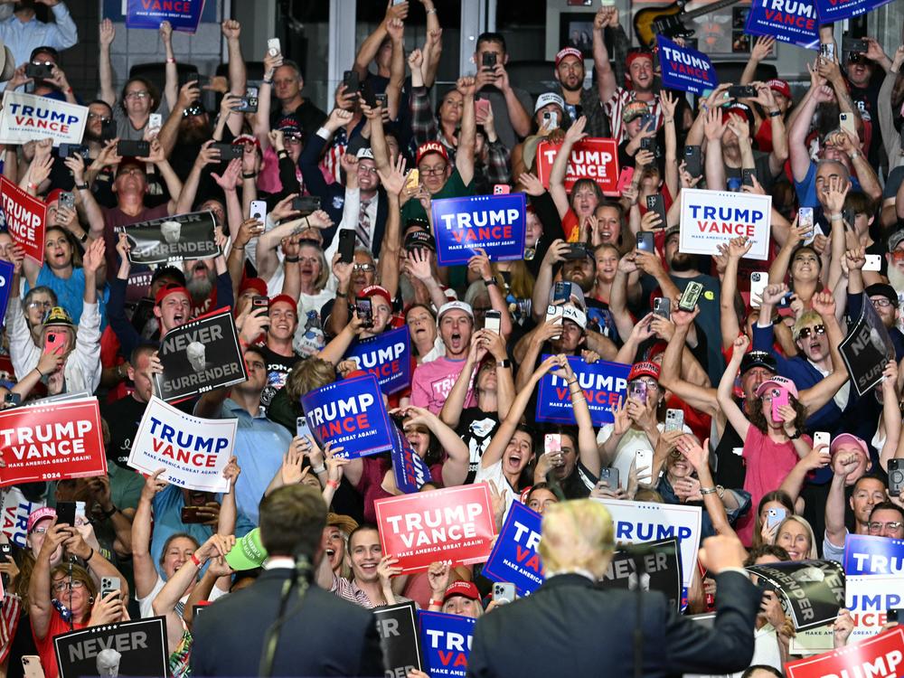 The crowd cheers as former president Donald Trump, right bottom, and Sen. JD Vance attend their first campaign rally together in Grand Rapids, Mich., on July 20.