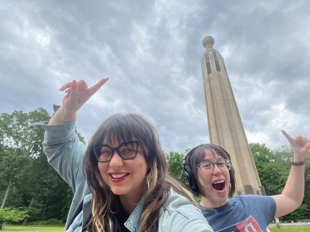 Photojournalist Amanda Andrade-Rhoades (left) and NPR correspondent Camila Domonoske take a selfie at the Thomas Edison Center at Menlo Park in Edison, N.J. An enormous light bulb on top is lit at night in honor of the famous inventor.