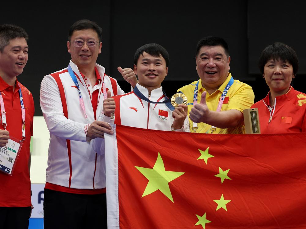 Gold medalist China's Xie Yu poses with team members at the end of the shooting 10m air pistol men's final during the Paris 2024 Olympic Games at Chateauroux Shooting Center. Chinese shooters have accounted for four of China's 13 gold medals.