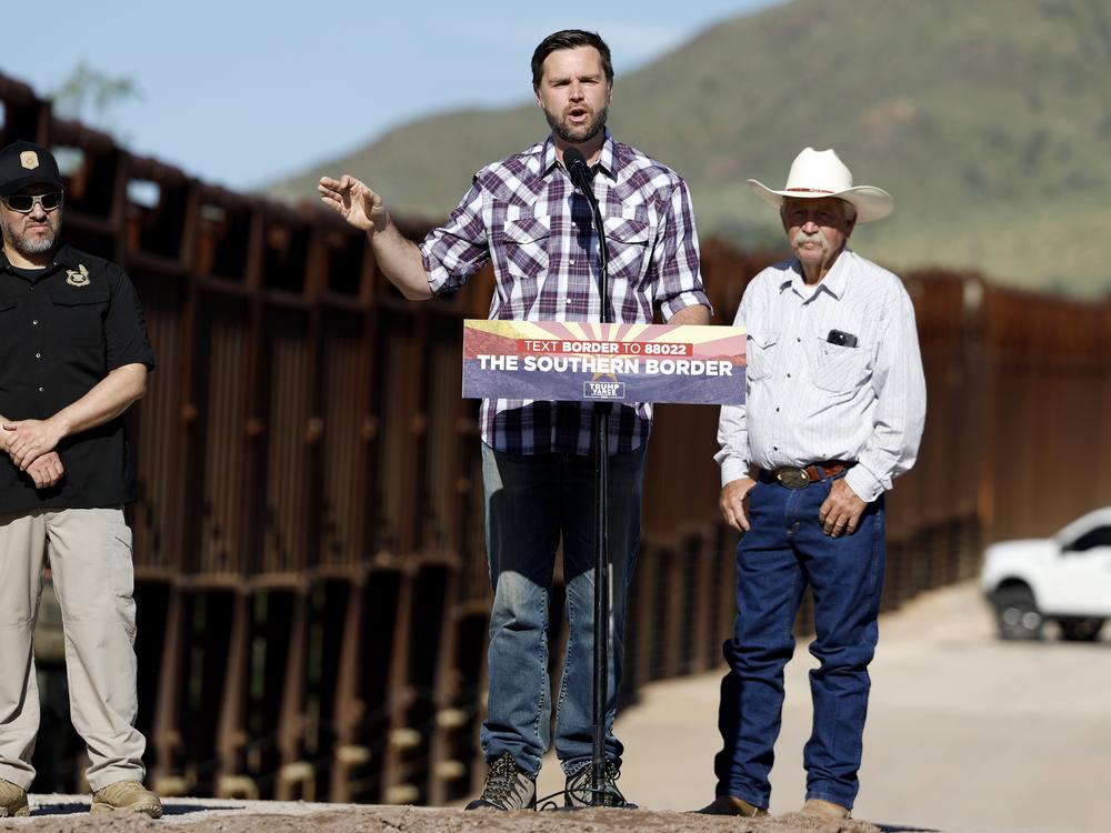 Republican vice presidential nominee Sen. JD Vance of Ohio delivers remarks alongside rancher John Ladd (right) and Paul A. Perez, president of the National Border Patrol Council, as Vance tours the U.S. Border Wall on Thursday in Montezuma Pass, Ariz. Vance is visiting the border on the final stop of his first visit to the Southwest as a vice presidential candidate. 