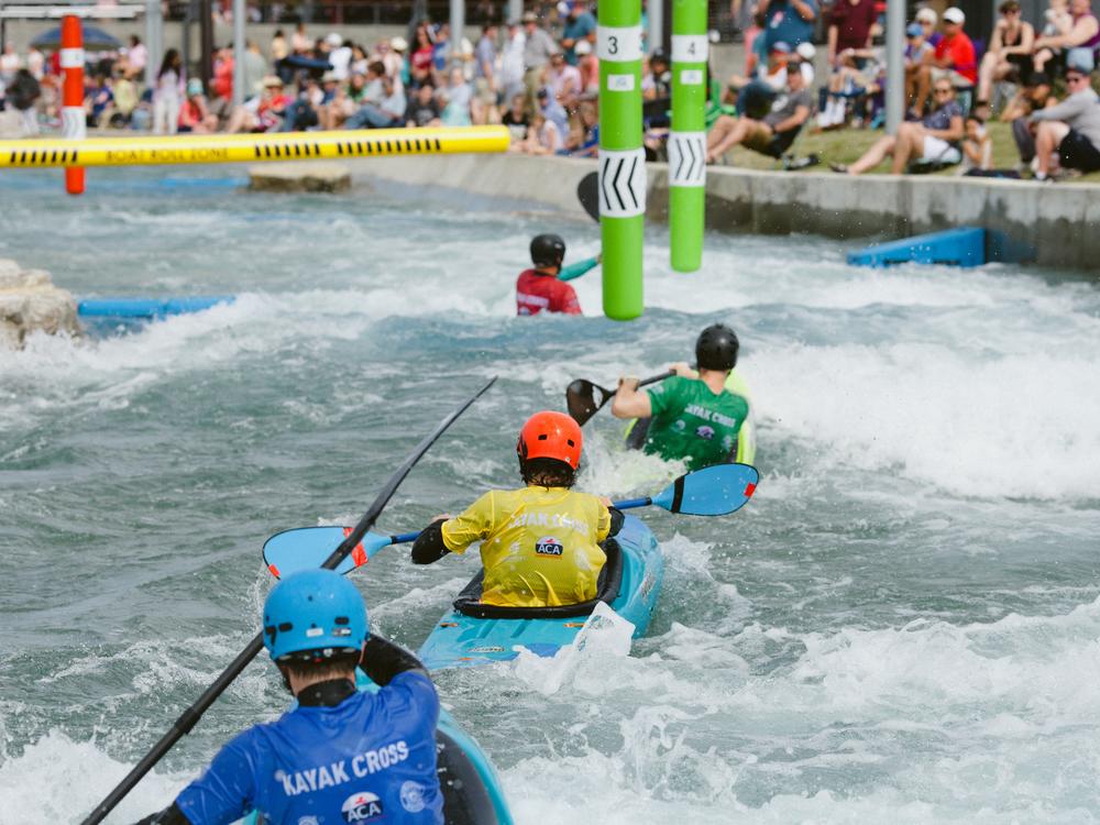 Competitors at the U.S. canoe and kayak cross slalom trials in Montgomery, Ala. float through the coarse in April 2024. 
