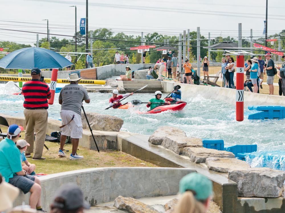 Spectators in Montgomery, Ala. watched the U.S. Canoe and Kayak Cross Olympic trials in April 2024. Racers tore through the course — dipping, rolling and dashing.