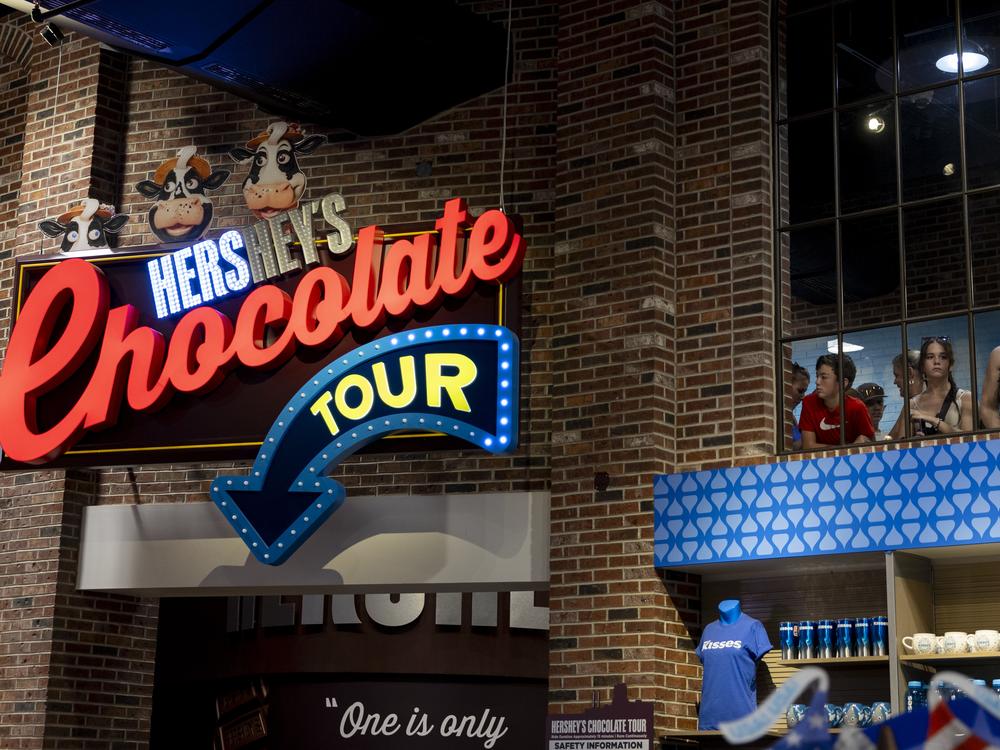 People line up for a kitschy ride that shows the process of making Hershey’s chocolate in Hershey, Pa.