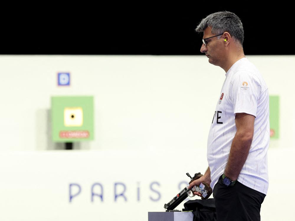 Turkey's Yusuf Dikec, pictured competing in the shooting 10m air pistol mixed team gold medal match at Chateauroux Shooting Center on Tuesday, went viral for his casual look. 