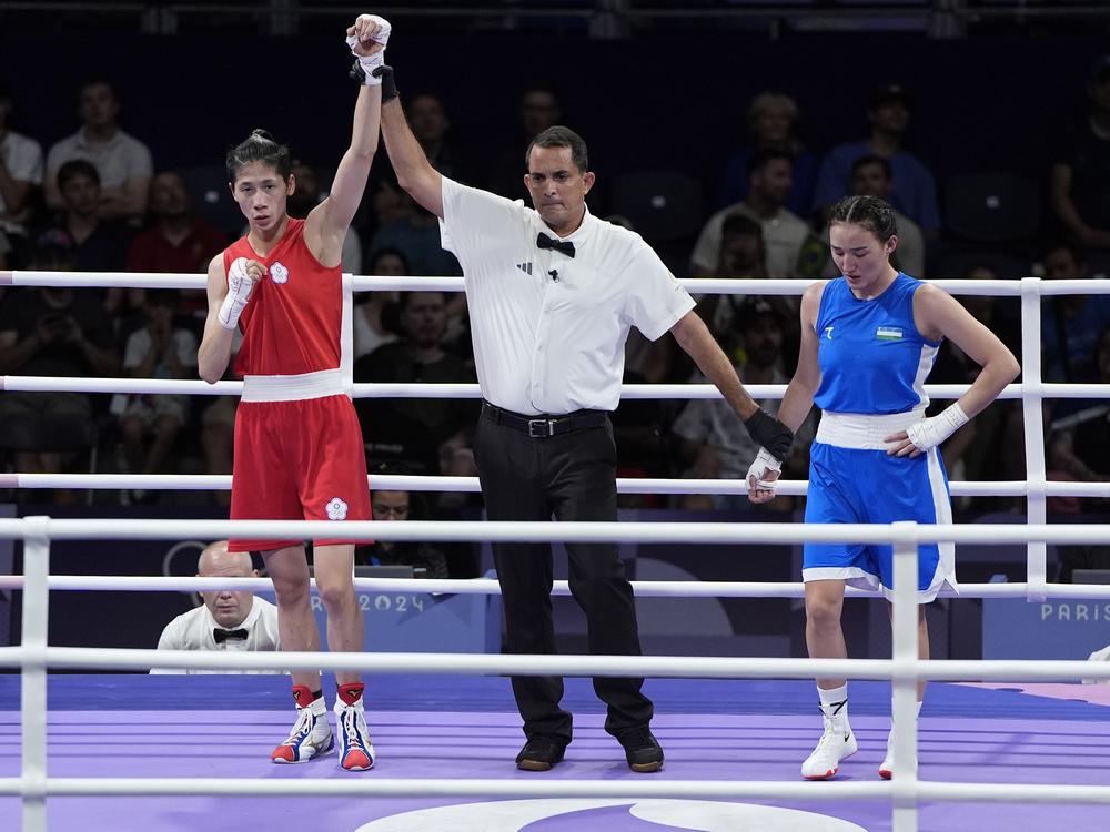 Taiwan's Lin Yu-ting, left, reacts after defeating Uzbekistan's Sitora Turdibekova in their women's 57 kg preliminary boxing match on Friday.