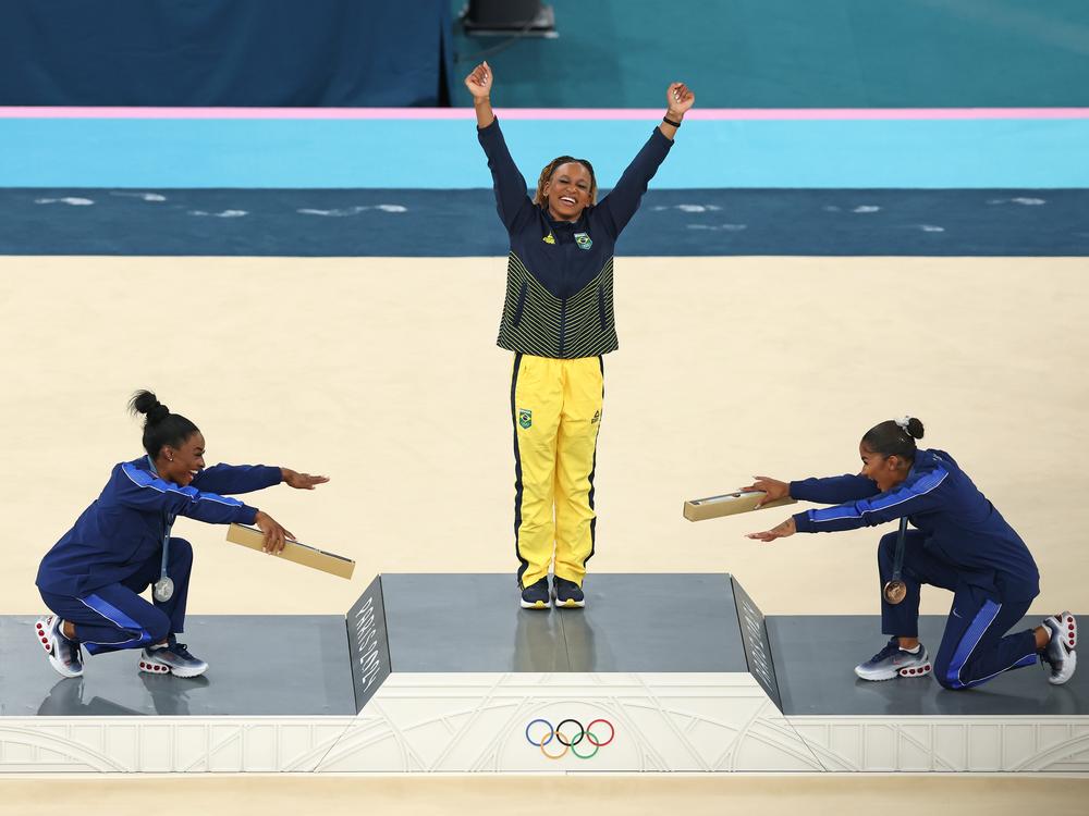 Gold medalist Rebeca Andrade (center) of Brazil along with silver medalist Simone Biles (left) and bronze medalist Jordan Chiles (right) of the U.S. celebrate on the podium at the women's gymnastics floor exercise medal ceremony on Monday at Bercy Arena in Paris.