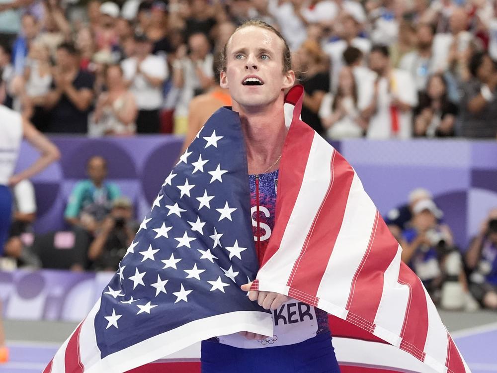 Cole Hocker, of the United States, celebrates setting an Olympic record and winning the men's 1,500-meter final at the Paris Summer Olympics.