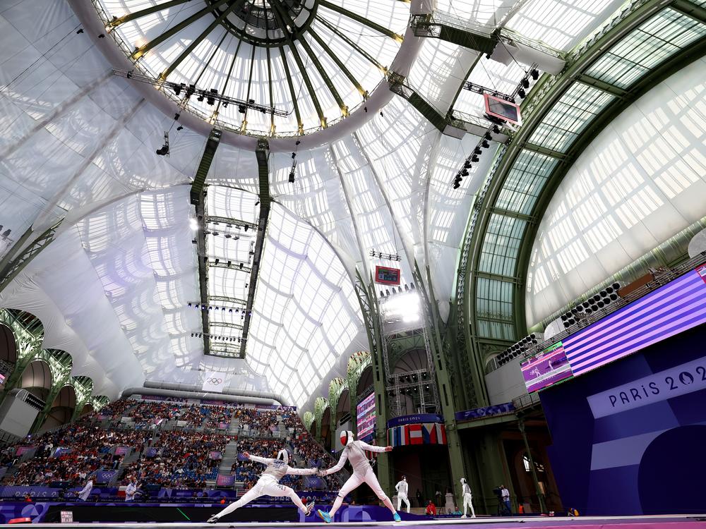 Lee Kiefer of Team United States (L) fought her way to a gold medal in the individual women's foil competition and helped lead her team to a first-ever gold medal against Italy, one of the best fencing teams in the world.