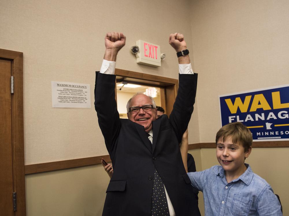 Then-Minnesota Democratic Rep. Tim Walz and his son Gus Walz celebrate while entering his election night party in August 2018 in St. Paul, Minn. Walz won the night's primary and went on to be elected governor.