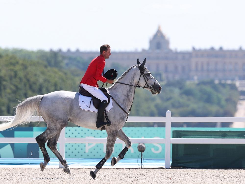 Germany's Christian Kukuk, who won the gold medal in the individual jumping final, rides a victory lap against the backdrop of the Chateau de Versailles. Competitors in the venue say they try not to admire the view until after they compete. 