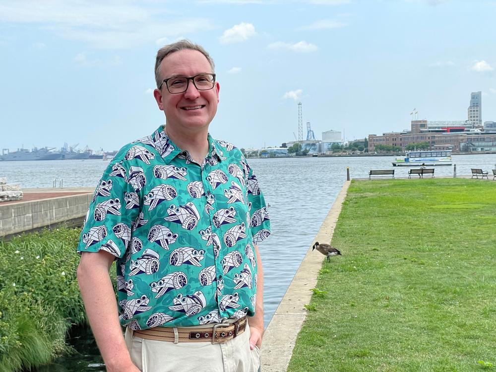  Waterfront Partnership vice president Adam Lindquist stands on a dock at Baltimore's Inner Harbor.