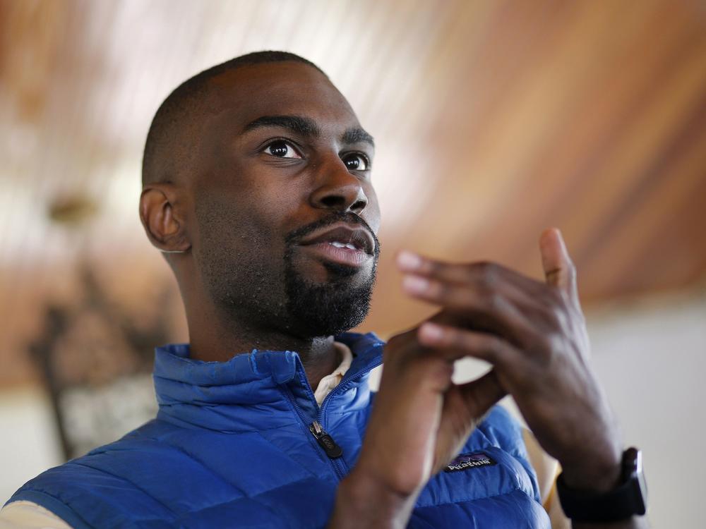 In this March 26, 2016, file photo, Black Lives Matter activist DeRay Mckesson chats with campaign volunteers in Baltimore.  