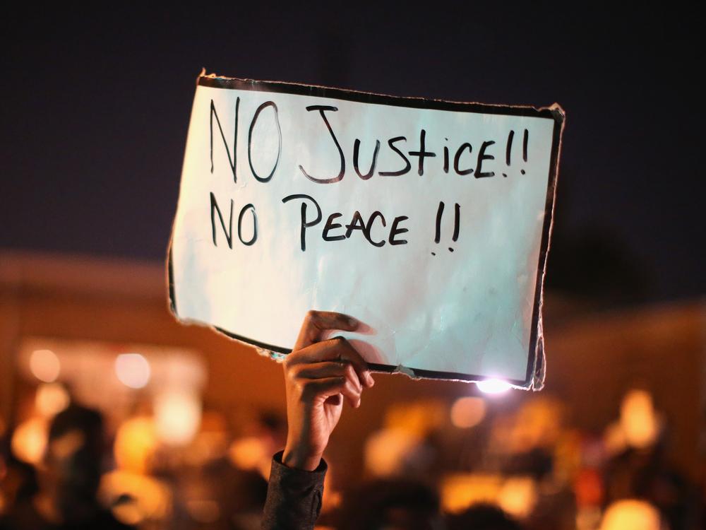 Demonstrators protest the killing of Michael Brown on Aug. 12, 2014, in Ferguson, Mo.