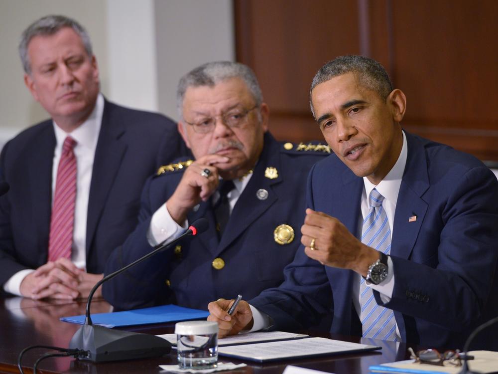 After Michael Brown's death, former President Obama — seen here with former Philadelphia police commissioner Charles Ramsey, center, and former New York City Mayor Bill De Blasio —  convened a task force to address policing in the country. Ramsey co-chaired the task force and told NPR he found the variety of voices brought together to be remarkable.