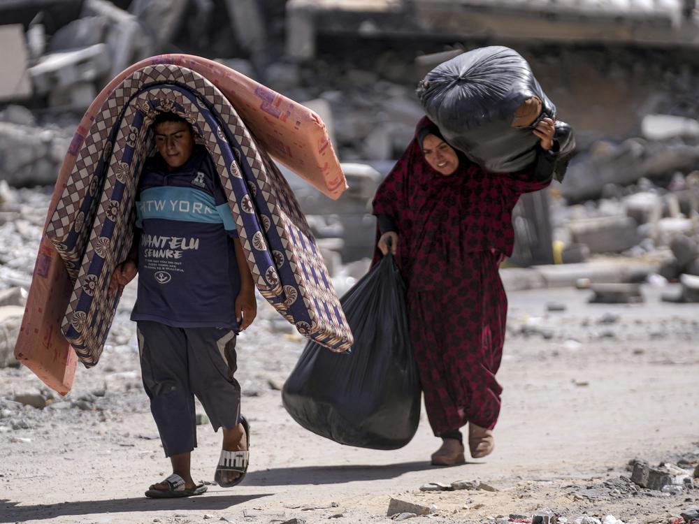 Palestinians displaced by the Israeli air and ground offensive on the Gaza Strip flee from Hamad City, following an evacuation order by the Israeli army to leave parts of the southern area of Khan Younis, Sunday. 