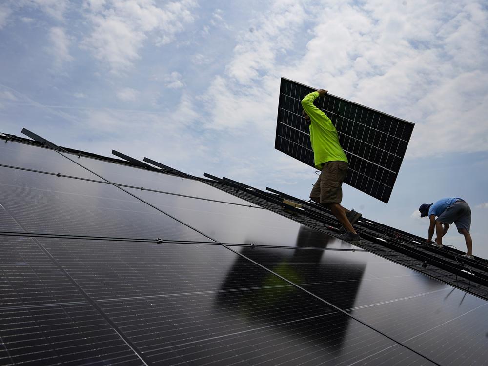 A crew installs a solar array on the roof of a home in Frankfort, Ky., in 2023. 