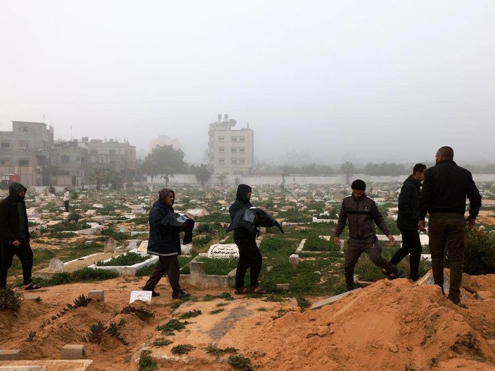 Mourners carry the bodies of Palestinian children Zein and Watin Saleh, killed along with the child Motaz Al-Mashukhi and his father Adel in an Israeli bombardment in Rafah, in the southern Gaza Strip, during their funeral on Feb. 9.