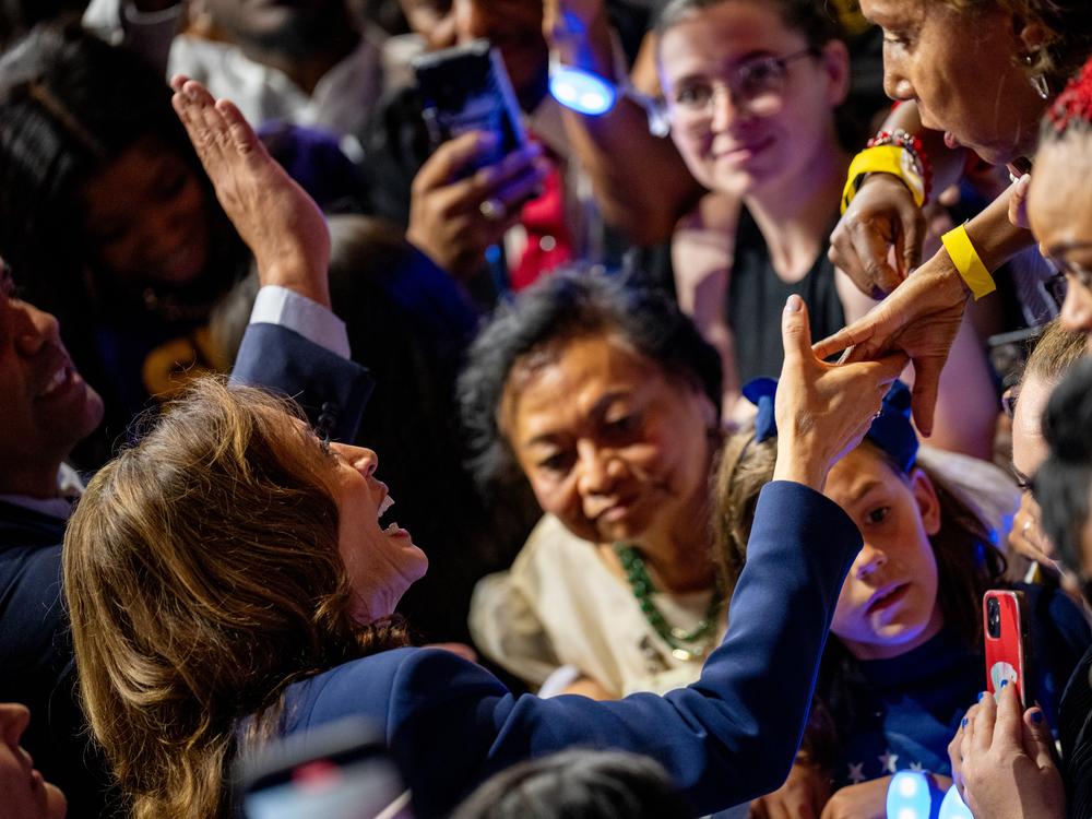 Vice President Harris shakes hands during an Aug. 6 rally in Philadelphia where she introduced her running mate, Minnesota Gov. Tim Walz.