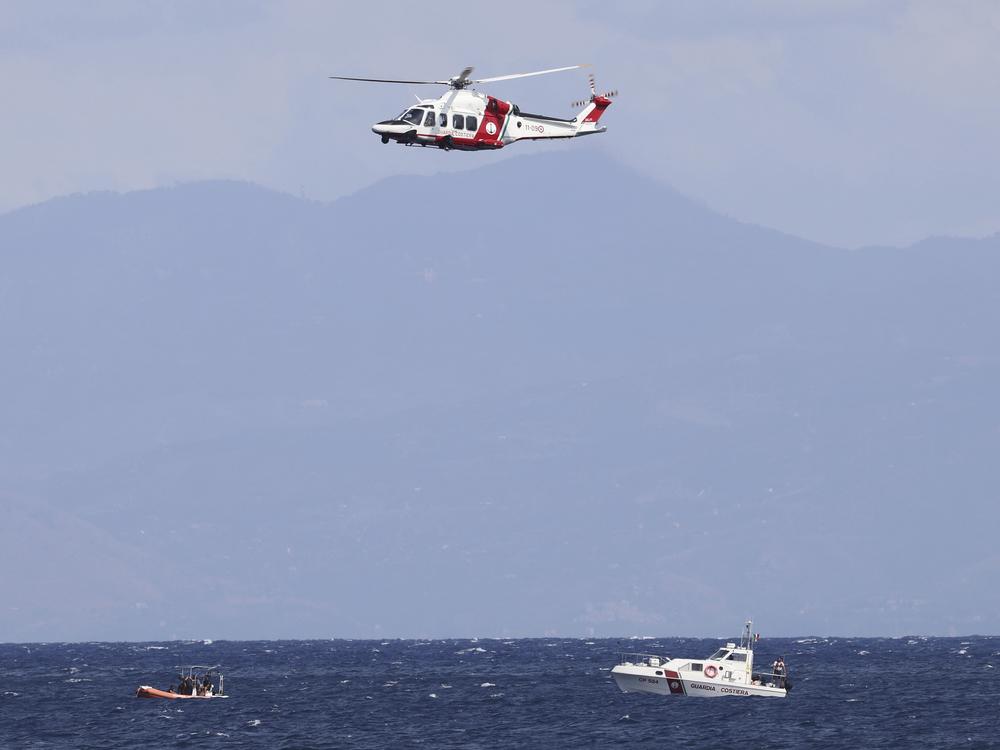 Emergency services at the scene of the search for a missing boat Monday in Porticello Santa Flavia, Italy. 