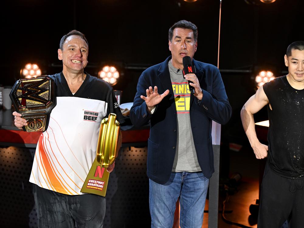 From left, Joey Chestnut, Rob Riggle and Takeru Kobayashi speak onstage during LIVE Chestnut vs. Kobayashi: Unfinished Beef at the Hyper X Arena at the Luxor in Las Vegas on Monday. 