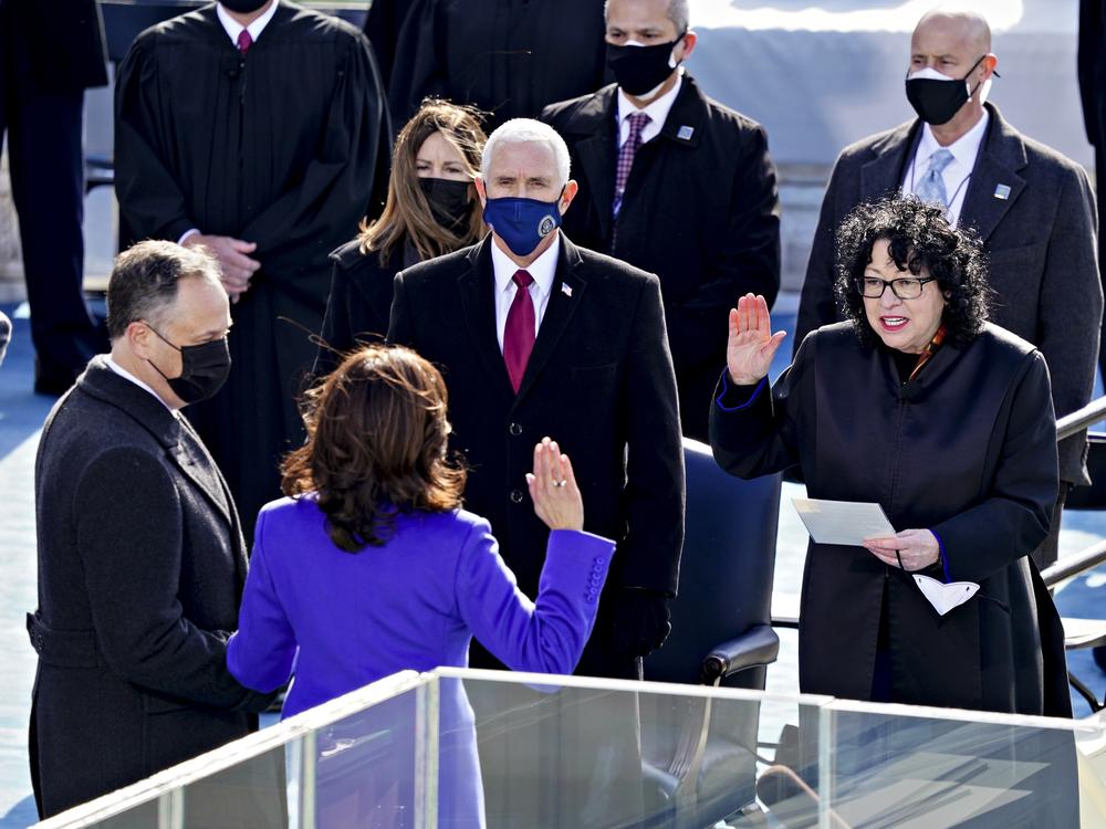 Supreme Court Justice Sonia Sotomayor (right) administers the oath of office to incoming Vice President Kamala Harris in front of the U.S. Capitol on Jan. 20, 2021, as outgoing Vice President Mike Pence (wearing blue mask) watches.