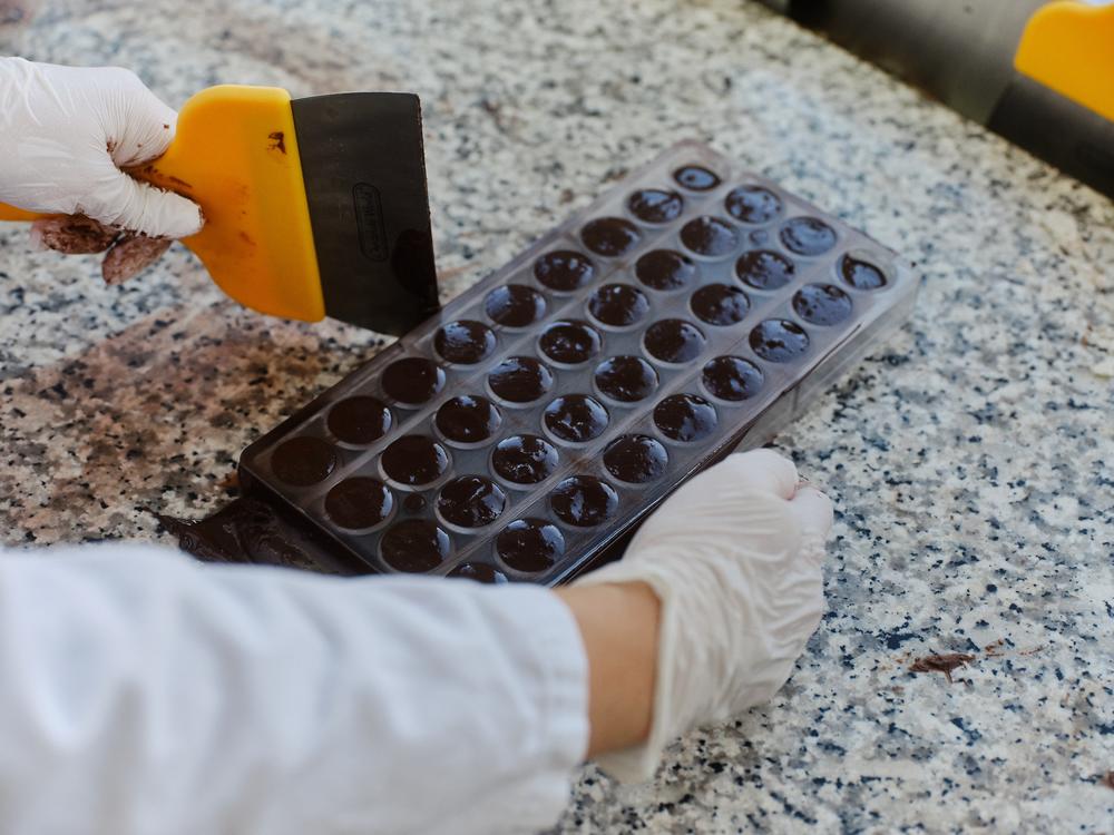 ChoViva, a cocoa-free chocolate alternative, is tested and processed by an employee at the testing lab of Planet A Foods.