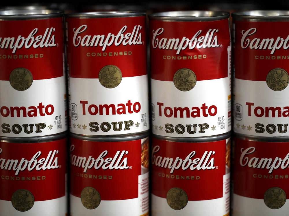 Cans of Campbell's soup are displayed on a shelf at a grocery store in Richmond, Calif., in 2019. The Campbell Soup Company says it's changing its corporate name to The Campbell’s Company.  