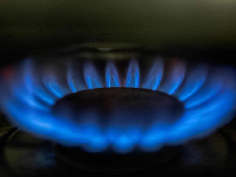 Gas-lit flames burn on a natural gas stove. California's Legislature passed a bill requiring health warning labels on new gas stoves.