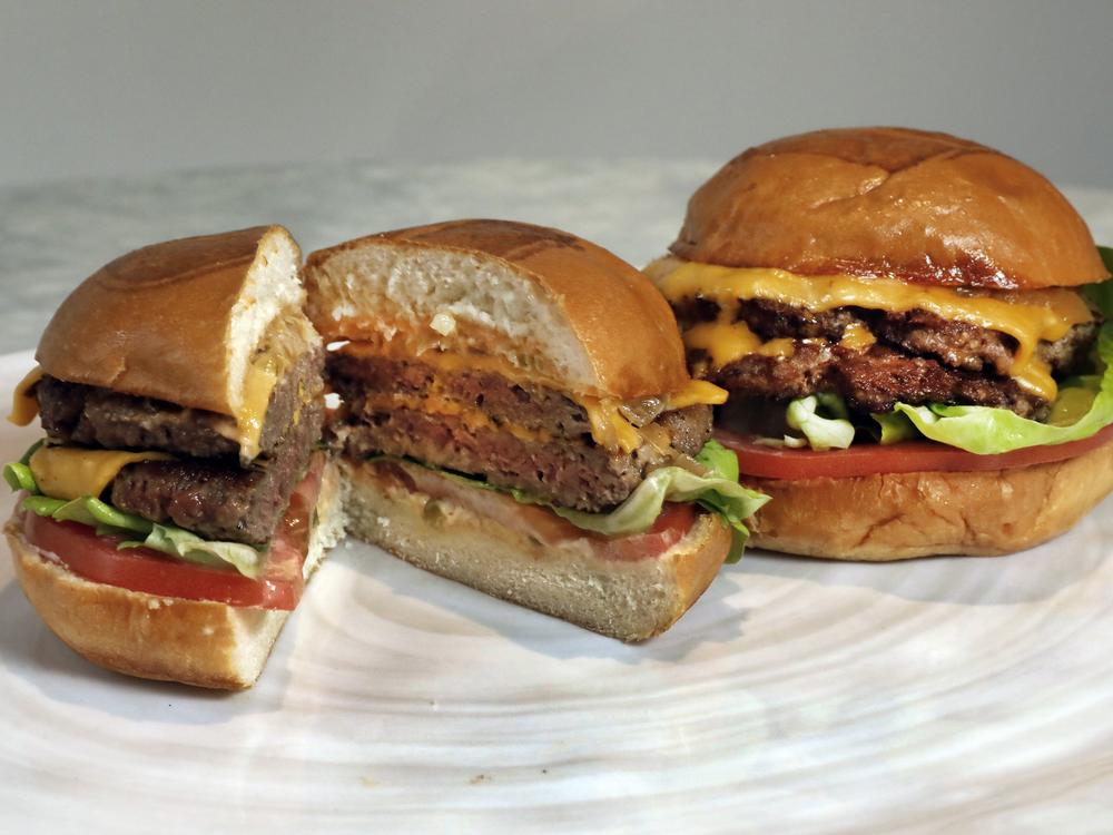 Plant-based burgers include the Original Impossible Burger (left) and a Cali Burger, from Umami Burger. Researchers say social pressures and stigmas can be an obstacle for some men looking to reduce meats like beef in their diets.