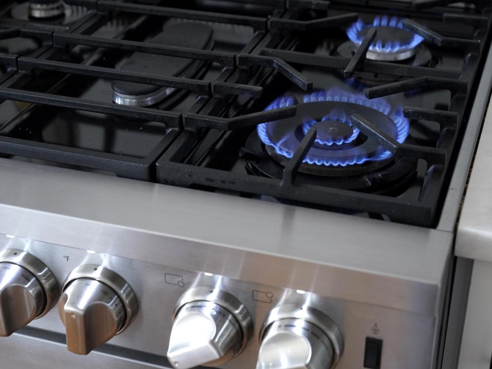 The blue flames of a natural gas stove emit harmful pollutants, such as nitrogen dioxide. Consumer and environmental watchdog groups want health warning labels on new gas stoves to let buyers know of the risks.