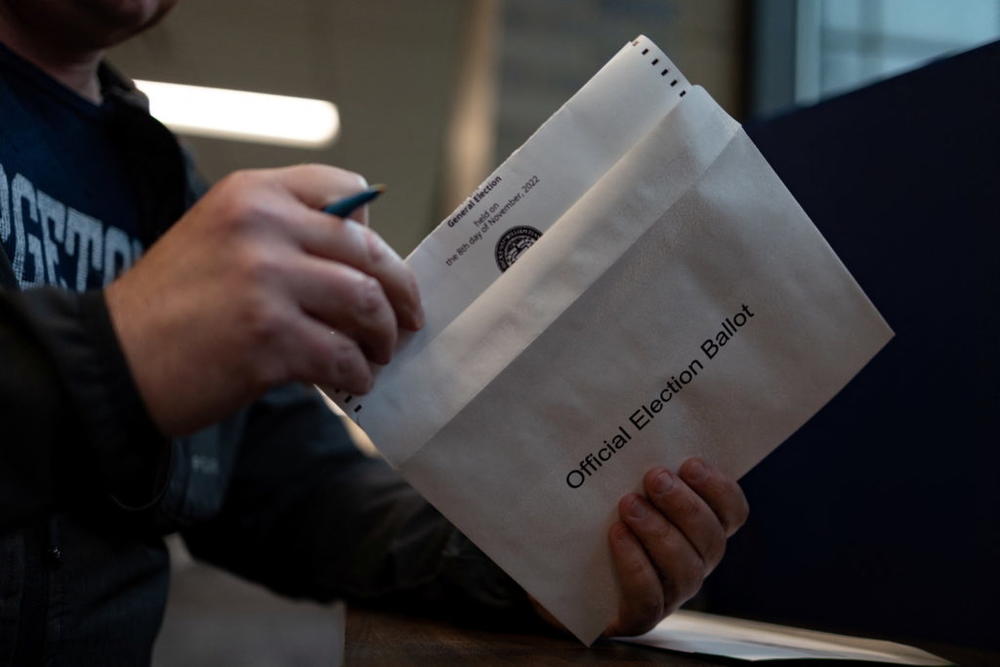 Tom Miller, 52, votes "On Demand" using an absentee or mail-in ballot in Doylestown, Pennsylvania, U.S. October 31, 2022. REUTERS/Hannah Beier