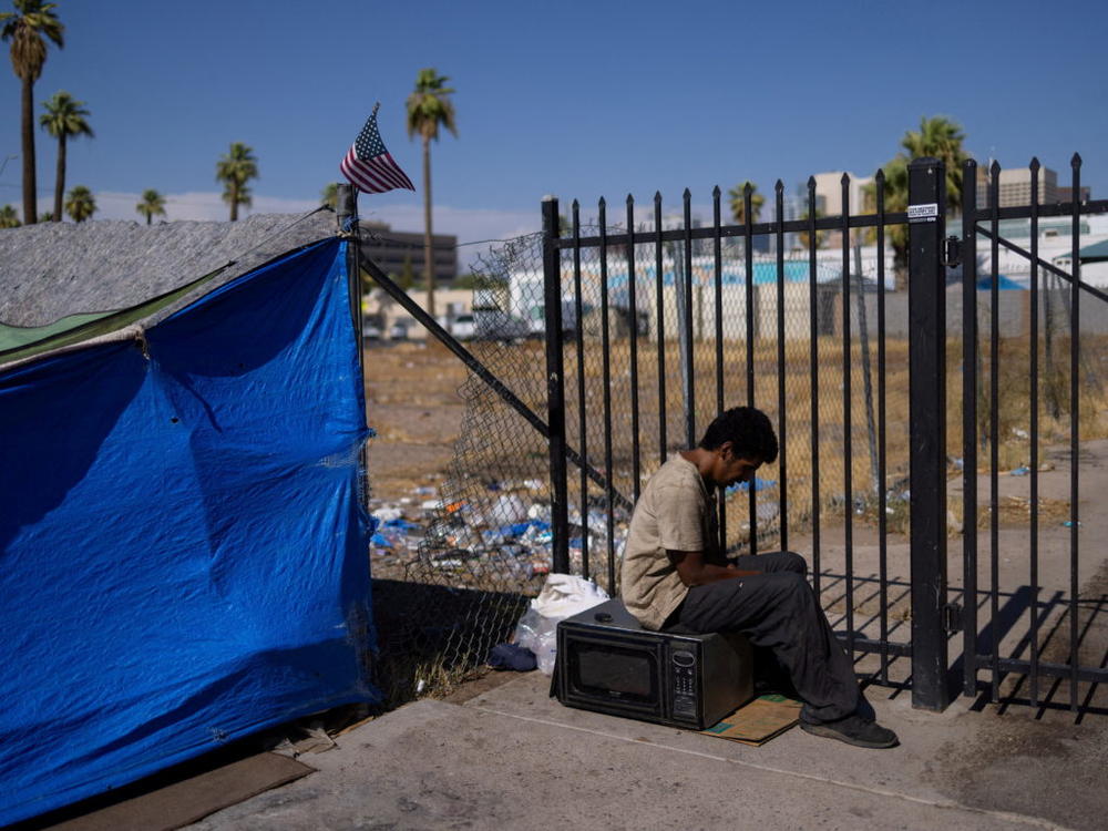 An unhoused man sits by a tent during a 27 days long heat wave with temperatures over 110 degrees Fahrenheit (43 degrees Celsius), in Phoenix, Arizona, U.S., July 26, 2023. Photo by Carlos Barria/REUTERS