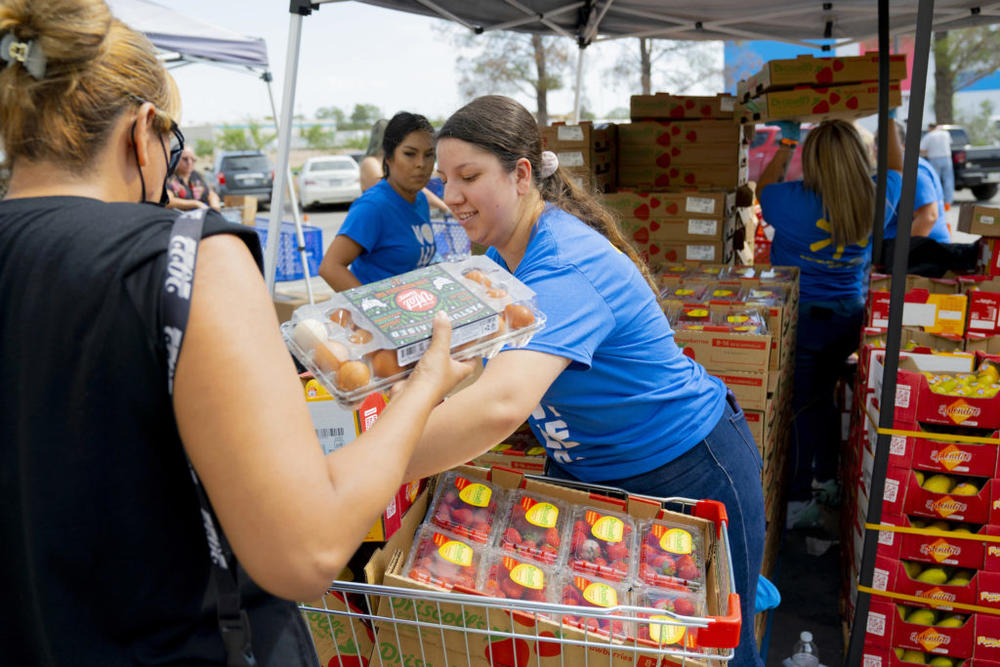 El Pasoans Fighting Hunger volunteers distribute food at a center in El Paso, Texas. The nonprofit received $9 million from philanthropist MacKenzie Scott in December 2020, shoring up the food bank's financial health after soaring food-assistance needs forced the charity to expand faster than it could handle. (Lonnie Valencia/El Pasoans Fighting Hunger via AP)