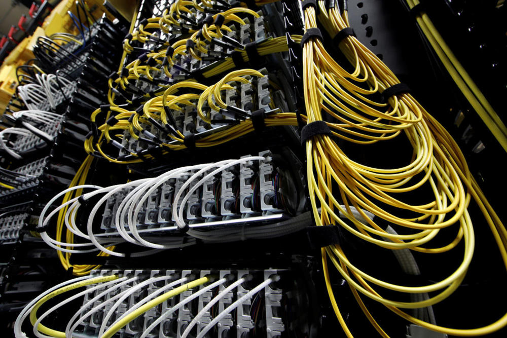 Cables run into the back of a server unit inside the data center of Equinix in Pantin, near Paris, France, December 7, 2016. REUTERS/Benoit Tessier