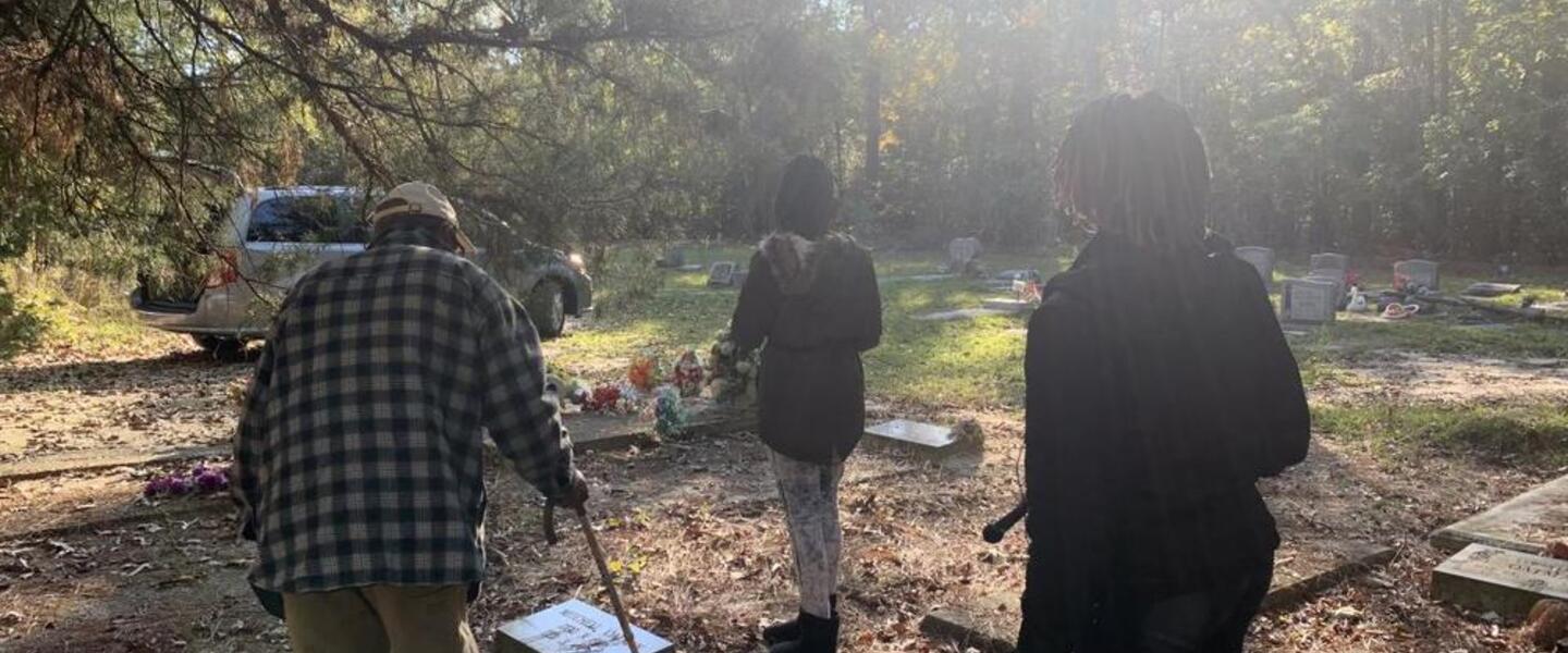 Lenton Oatman guides students from the Jessye Norman School of the Arts through Flat Rock Cemetery in Matthews, Ga., about 40 minutes south of Augusta. That's where his nephew, Charles Oatman, is buried.