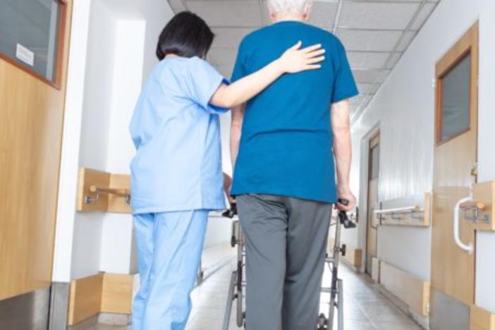 Nurse walking with elderly patient
